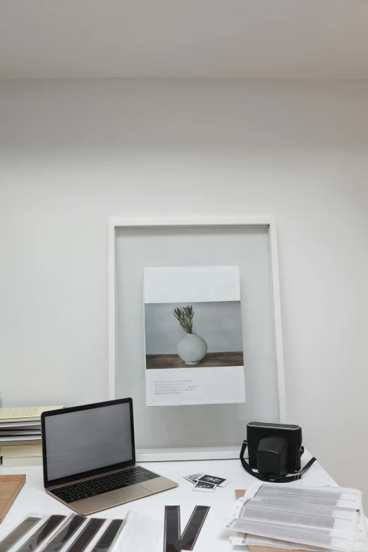 a laptop computer sitting on top of a white desk, a poster, inspired by jeonseok lee, postminimalism, low quality photo, framed in image, office/thrift store/social hall, phone photo