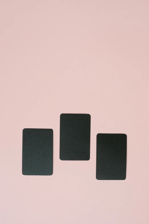 three black square magnets on a pink wall, unsplash, playing card back, dwell, pure black, blackout