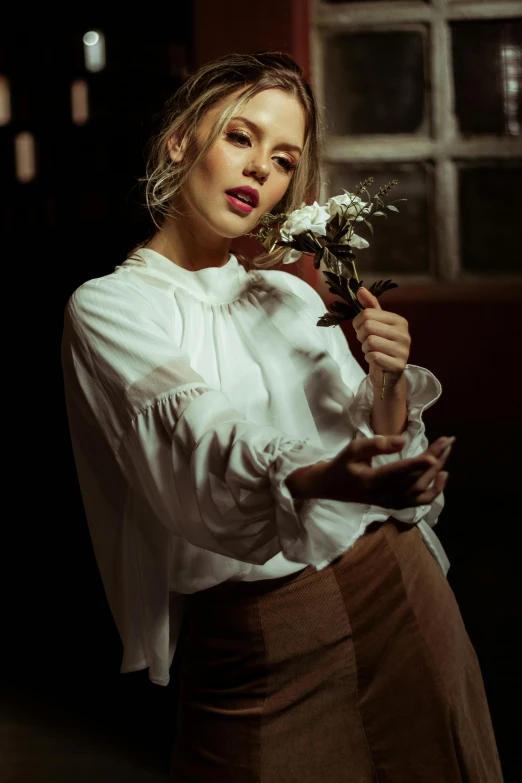 a woman in a white shirt and brown skirt holding a flower, inspired by Elsa Bleda, pexels contest winner, portrait of scarlett johansson, roses in cinematic light, ( low key light ), sydney sweeney