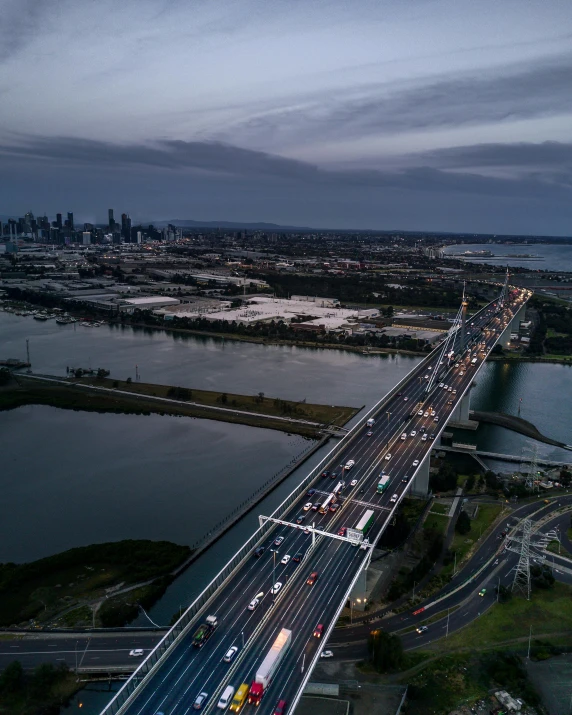 a freeway bridge over a large body of water, an album cover, pexels contest winner, melbourne, high traffic, overview, non-binary