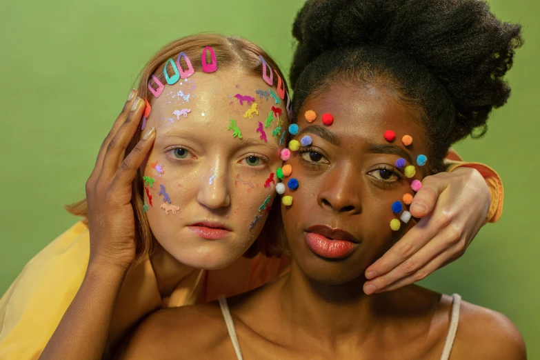 two girls with face paint posing for a picture, an album cover, by Lily Delissa Joseph, trending on pexels, feminist art, made of dots, plasticine models, diverse, skin care