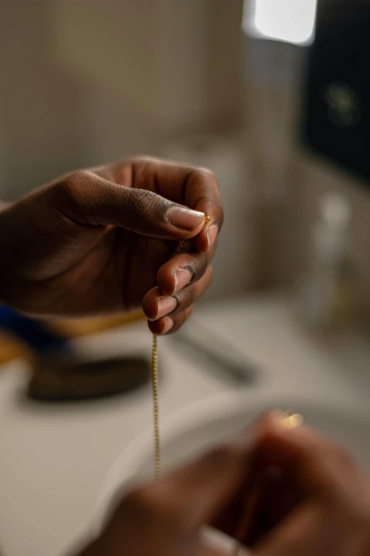 a close up of a person holding a string, liquid gold, doing a prayer, plating, unedited