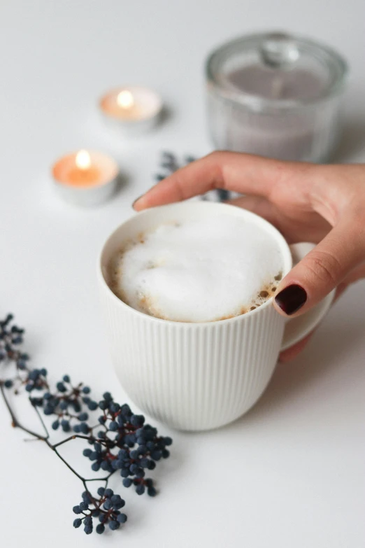 a close up of a person holding a cup of coffee, waxy candles, gentle mists, profile image, thumbnail