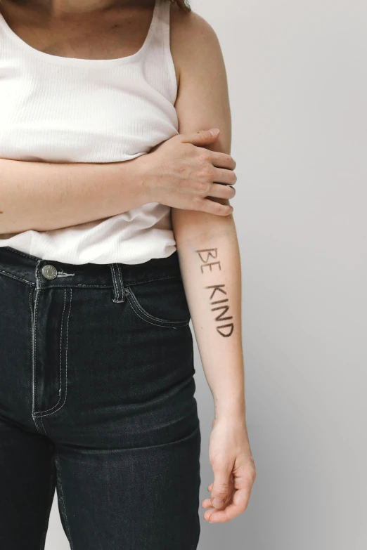 a woman with a tattoo on her arm, a tattoo, by Nina Hamnett, trending on unsplash, kindness, on white background, labels, standing upright like people