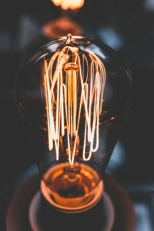 a light bulb sitting on top of a table, intricate lights, electric sparks, bold lighting, sunlit