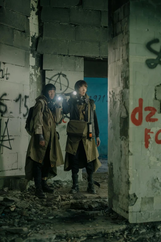 a couple of men standing next to each other in a building, graffiti, postapocalyptic explorer, movie frame still, in trenches, gen z