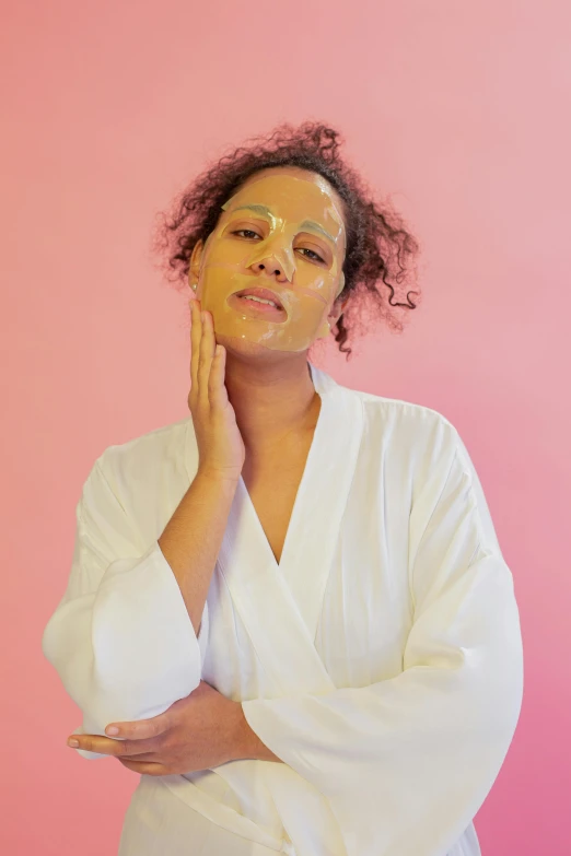 a woman in a bathrobe posing for a picture, by Dulah Marie Evans, peeling face skin, mixed race, pink, eucalyptus