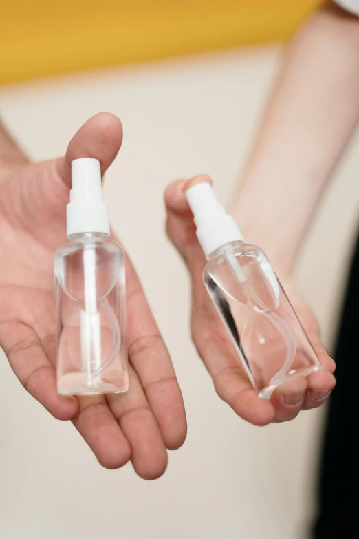 a person holding a bottle of hand sanitizer and another person holding a bottle of hand sanitizer, by Nina Hamnett, see - through, silicone skin, size, thumbnail