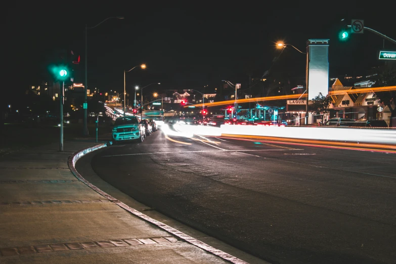 a city street filled with lots of traffic at night, pexels contest winner, oceanside, thumbnail, 1 2 9 7, carson ellis