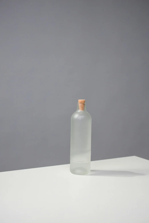 a glass bottle sitting on top of a white table, by Harvey Quaytman, minimalism, hero prop, cedar, clear background, large tall