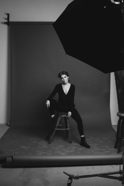 a black and white photo of a woman sitting on a stool, inspired by Peter Lindbergh, portrait of timothee chalamet, anna kendrick, studio medium format photograph, sittin