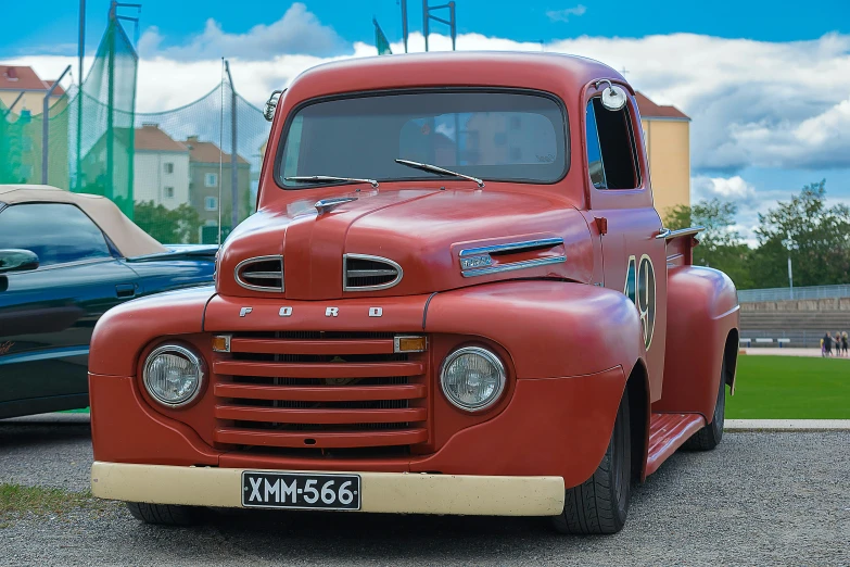 an old red truck parked in a parking lot, a colorized photo, by Sven Erixson, pexels contest winner, photorealism, ford, magnificent oval face, 8k 4k, portrait of a old
