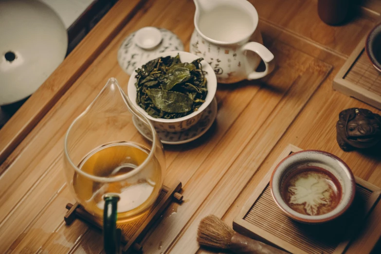 a tea pot sitting on top of a wooden table, inspired by Kanō Shōsenin, trending on unsplash, green robes, avatar image, eating, 90's photo