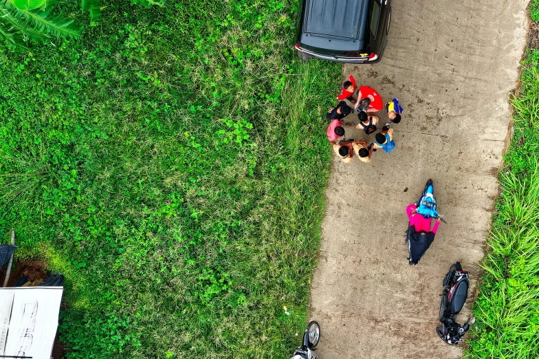 a group of people standing on top of a dirt road, by Adam Marczyński, pexels contest winner, game top down view, people resting on the grass, racing, calmly conversing 8k