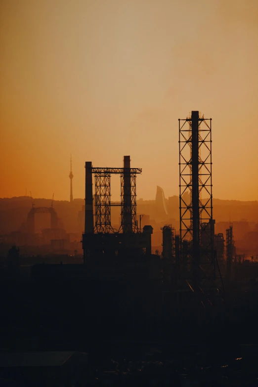 an oil refinery at sunset with mountains in the background, by Tobias Stimmer, pexels contest winner, renaissance, city background in silhouette, rusty metal towers, hazy, hannover