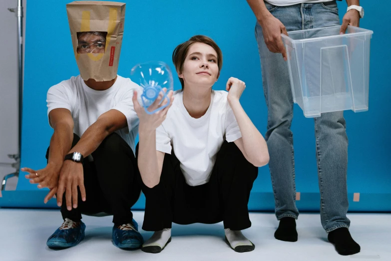 a couple of people sitting next to each other, an album cover, inspired by Sarah Lucas, pexels contest winner, trash bag on head, emma watson with anxious, pale blue faces, group photo