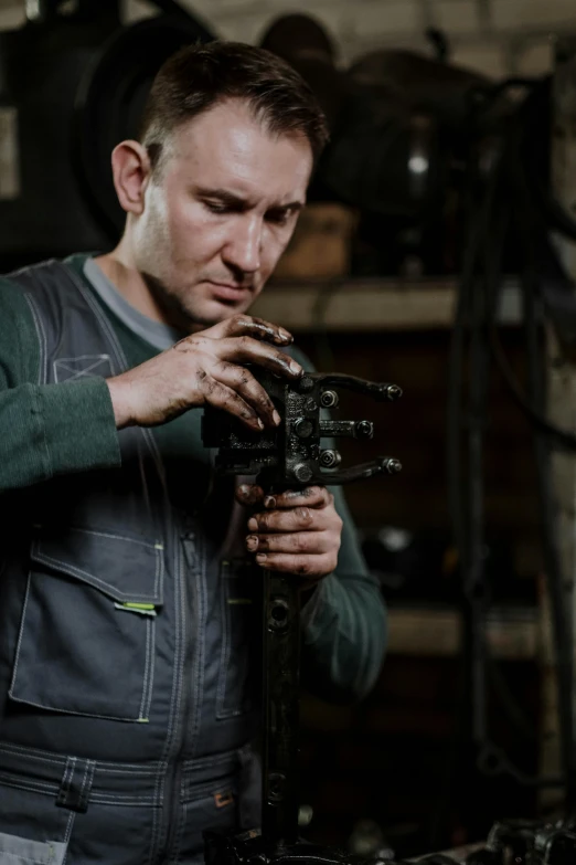 a man working on a camera in a garage, a portrait, by Andries Stock, arbeitsrat für kunst, professional gunsmithing, high quality upload, add text: auto repair, with mechanical arms that fix it