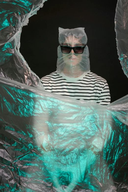 a man wearing a plastic bag over his face, an album cover, trending on tumblr, holography, tardigrade wearing sunglasses, photo from a promo shoot, slide show, lachlan bailey