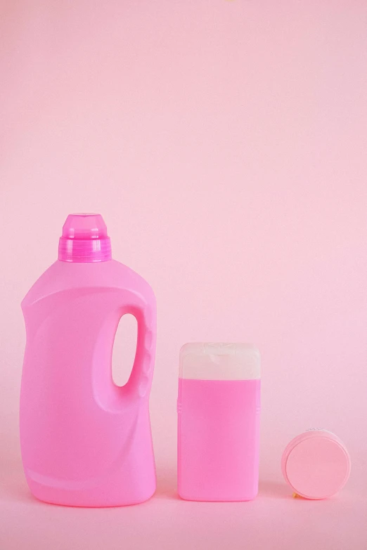 a pink jug and a glass of milk on a pink background, by Olivia Peguero, pexels contest winner, plasticien, bottles covered in wax, handsome, wash, litter