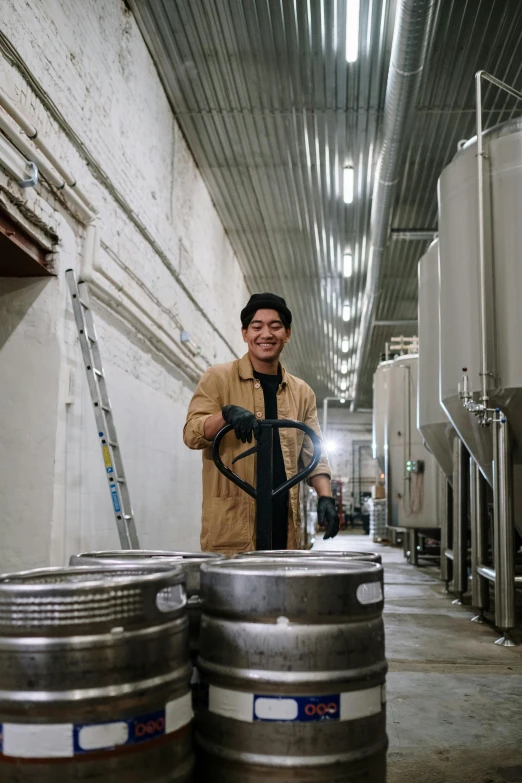 a man that is standing next to some kegs, process art, darren quach, taking control while smiling, william warehouse, looking straight to camera