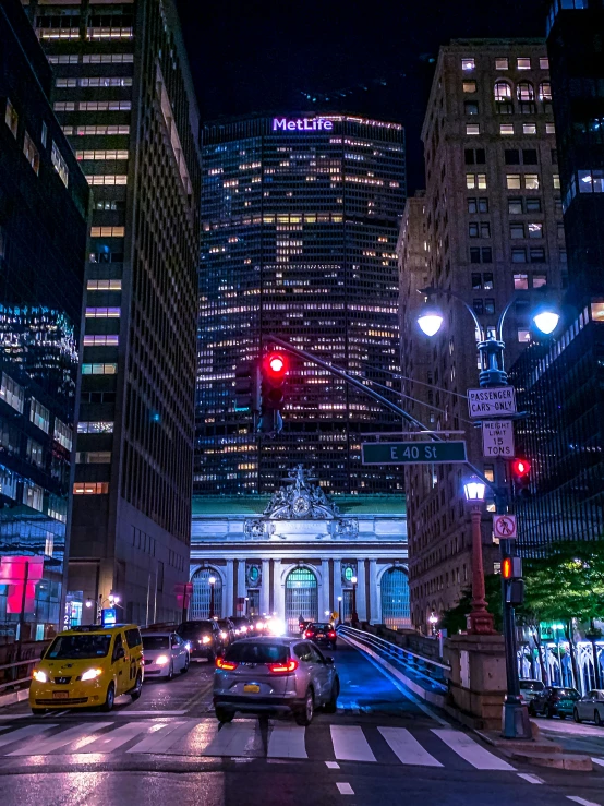 a city street filled with lots of traffic at night, by Bernie D’Andrea, pexels contest winner, new york buildings, giant majestic archways, high quality photo, 2 0 2 2 photo