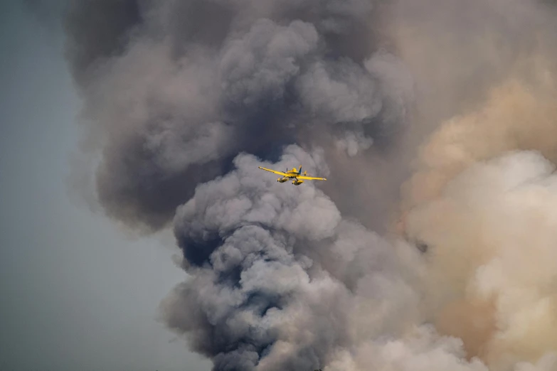 a plane flying in front of a cloud of smoke, a portrait, by Daren Bader, pexels contest winner, hurufiyya, yellow charcoal, bushfire, avatar image