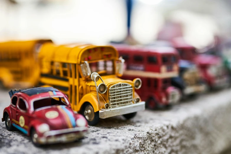 a group of toy cars sitting next to each other, a tilt shift photo, unsplash, photorealism, yellow school bus, antique, 15081959 21121991 01012000 4k, instagram photo