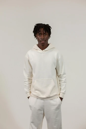 a man standing with his hands in his pockets, an album cover, inspired by Xanthus Russell Smith, unsplash, renaissance, beige hoodie, all white, offwhite, thumbnail