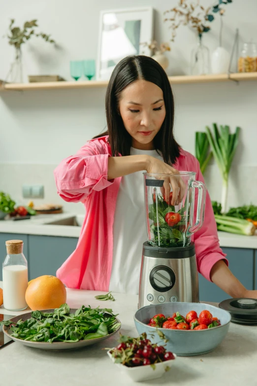 a woman is making a smoothie in the kitchen, pexels contest winner, avatar image, asian female, made of high tech materials, premium quality