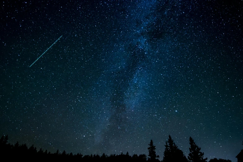 a sky filled with lots of stars next to a forest, pexels, space art, blue fireball, rectangle, shooting star, black