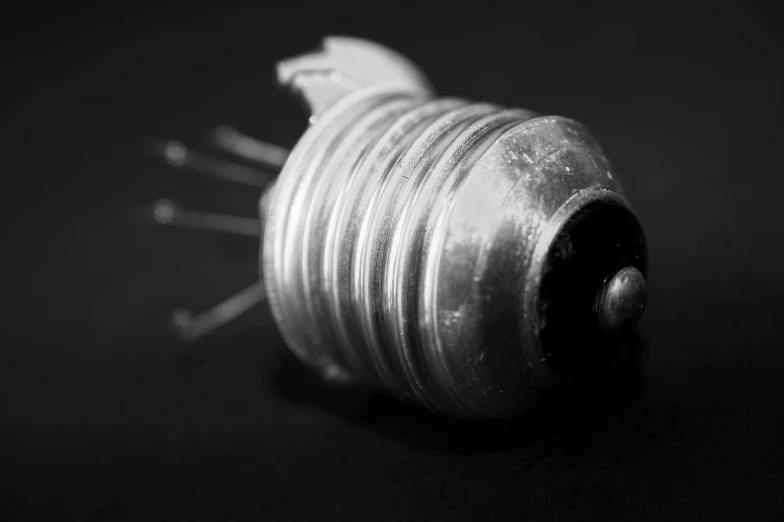 a black and white photo of a snail shell, purism, wires cybernetic implants, nixie tube, miniature product photo, cyberpunk bee