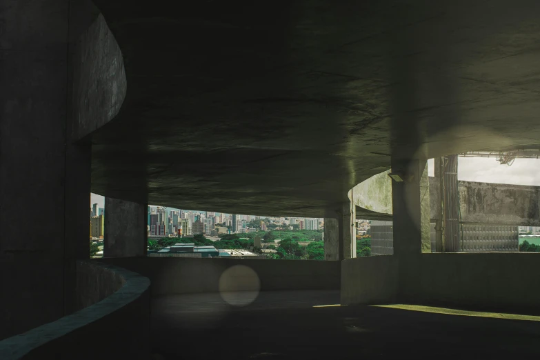 a man riding a skateboard up the side of a ramp, a matte painting, inspired by Elsa Bleda, unsplash contest winner, brutalism, sao paulo, view from inside, shafts of sunlight in the centre, panoramic anamorphic