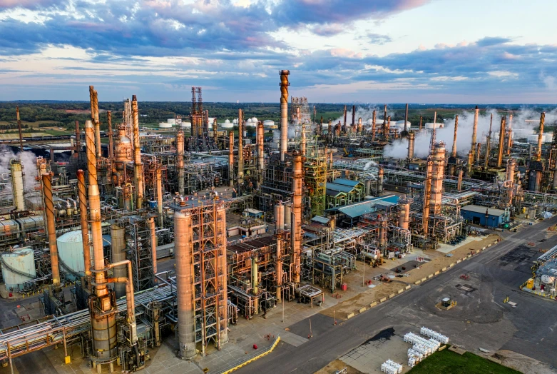 an oil refinery with a lot of smoke coming out of it, a portrait, by Jacob Burck, pexels contest winner, renaissance, drone photograpghy, in louisiana, vibrant aesthetic, wide high angle view