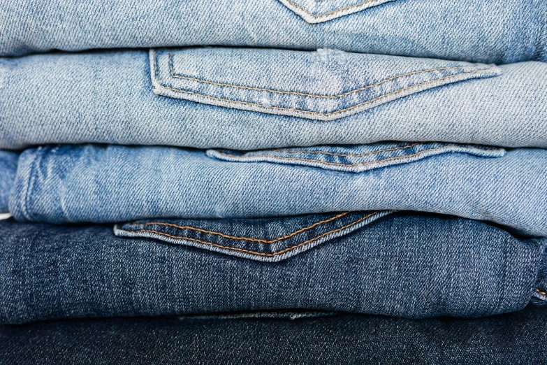 a stack of jeans stacked on top of each other, by Tom Wänerstrand, trending on unsplash, fan favorite, avatar image, washed colors, super detailed image