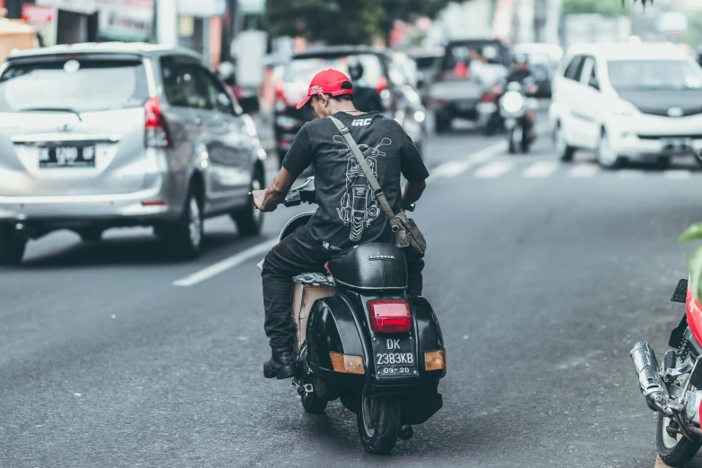 a man riding on the back of a motorcycle down a street, pexels contest winner, malaysian, avatar image, deus ex machina, urban patrol