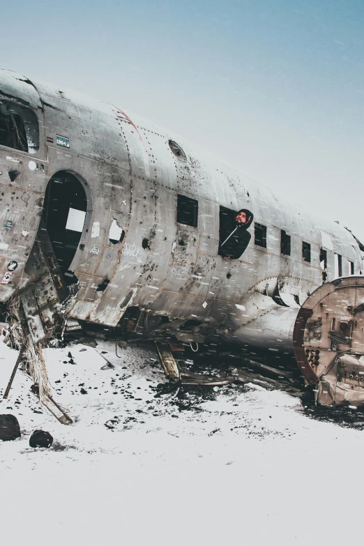 a large airplane sitting on top of a snow covered field, pexels contest winner, auto-destructive art, dust clouds and building debris, portrait of a sunken ship, destroyed robot dogs remains, mining scrap metal