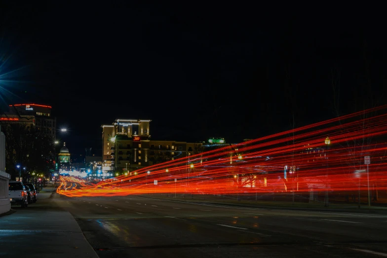 a bus driving down a city street at night, by Ryan Pancoast, unsplash contest winner, art photography, albuquerque, lightpainting, flashy red lights, downtown jacksonville florida