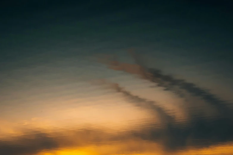 a large jetliner flying through a cloudy sky, a picture, inspired by Elsa Bleda, unsplash, lyrical abstraction, refracted sunset, liquid gold, humid evening, color ( sony a 7 r iv