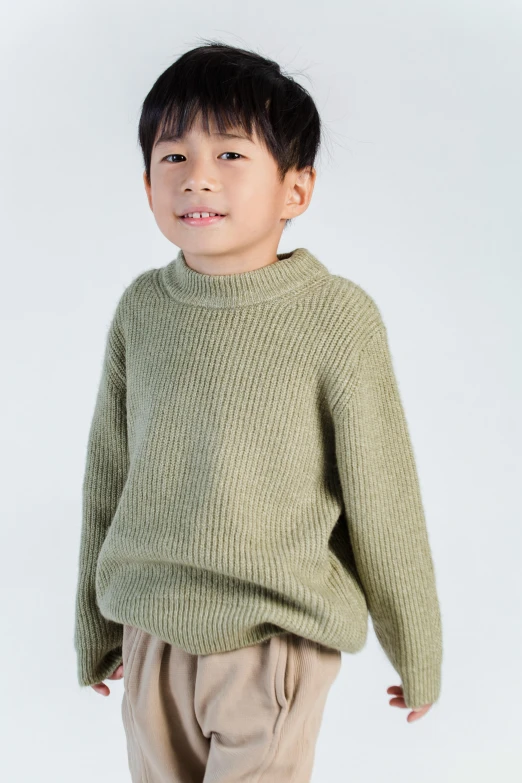 a young boy in a green sweater and khaki pants, by Tooth Wu, trending on pexels, japanese collection product, made of wool, on clear background, promo image