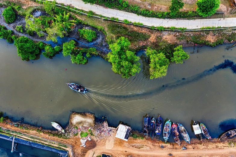 a boat traveling down a river next to a forest, by Daniel Lieske, pexels contest winner, hurufiyya, flat lay, in style of lam manh, canals, maintenance photo