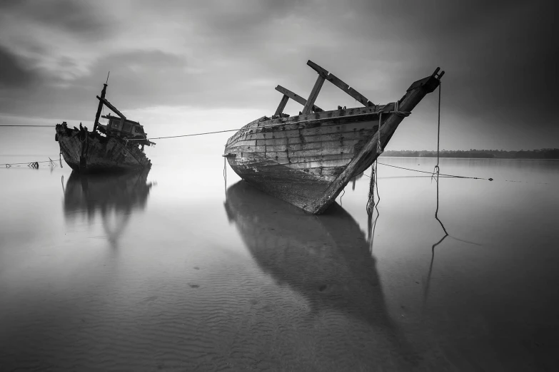 two boats sitting on top of a body of water, a black and white photo, by Dariusz Zawadzki, unsplash contest winner, broken shackles, portrait!!!!, dawn cgsociety, islamic