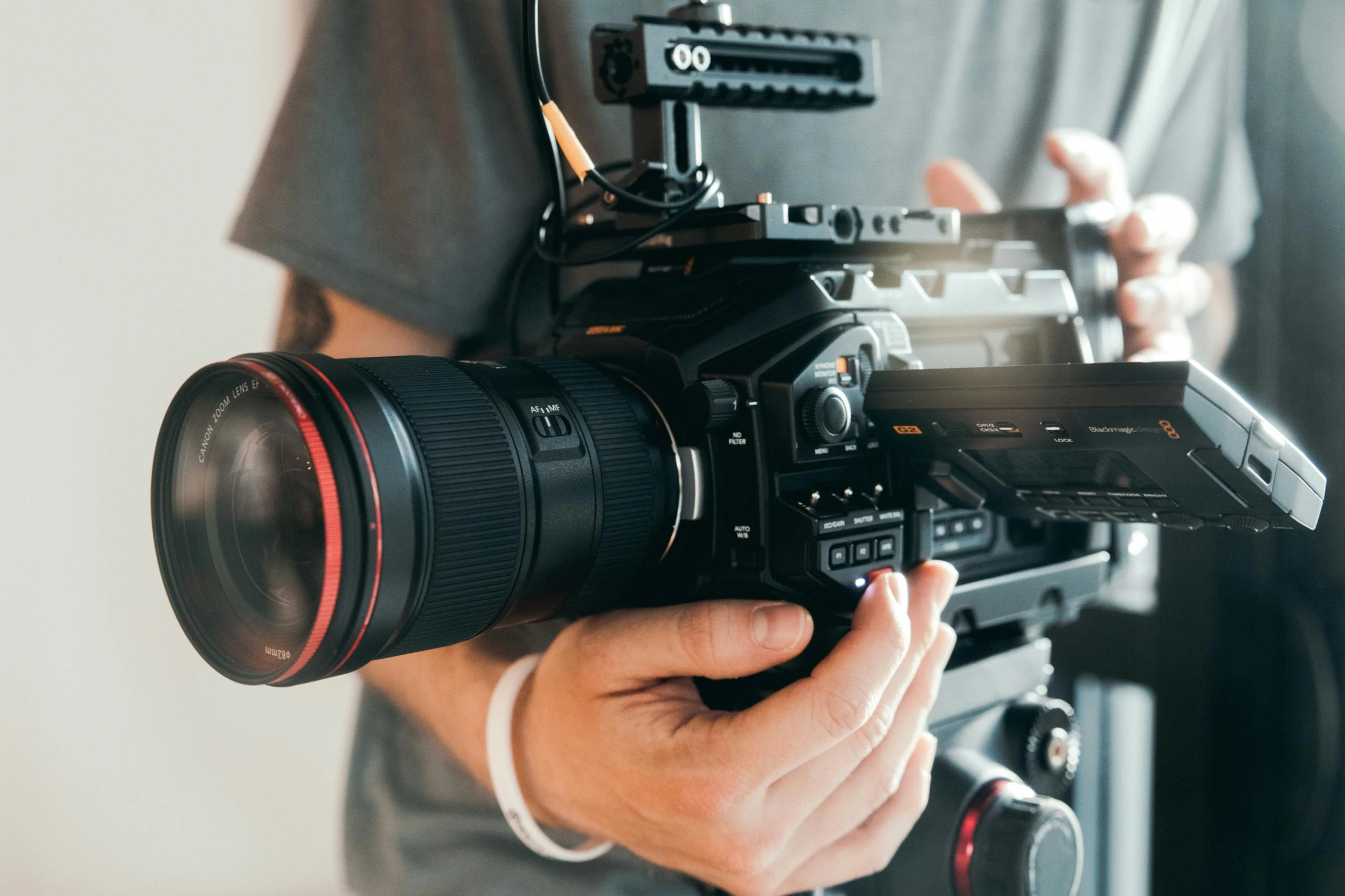 a close up of a person holding a camera, pexels contest winner, video art, arri alfa anamorphic lens, tv commercial, towering over the camera, production ig
