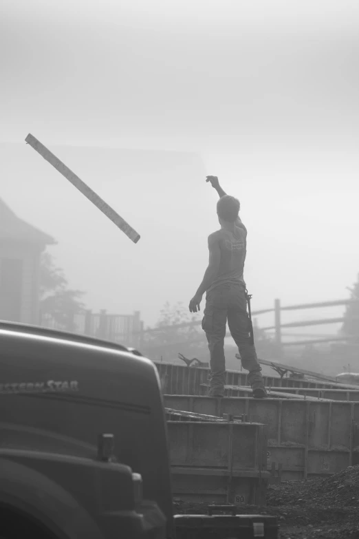 a black and white photo of a man on a bridge, inspired by Gregory Crewdson, trending on cgsociety, fornite game. octane render, construction site, early foggy morning, holding axe