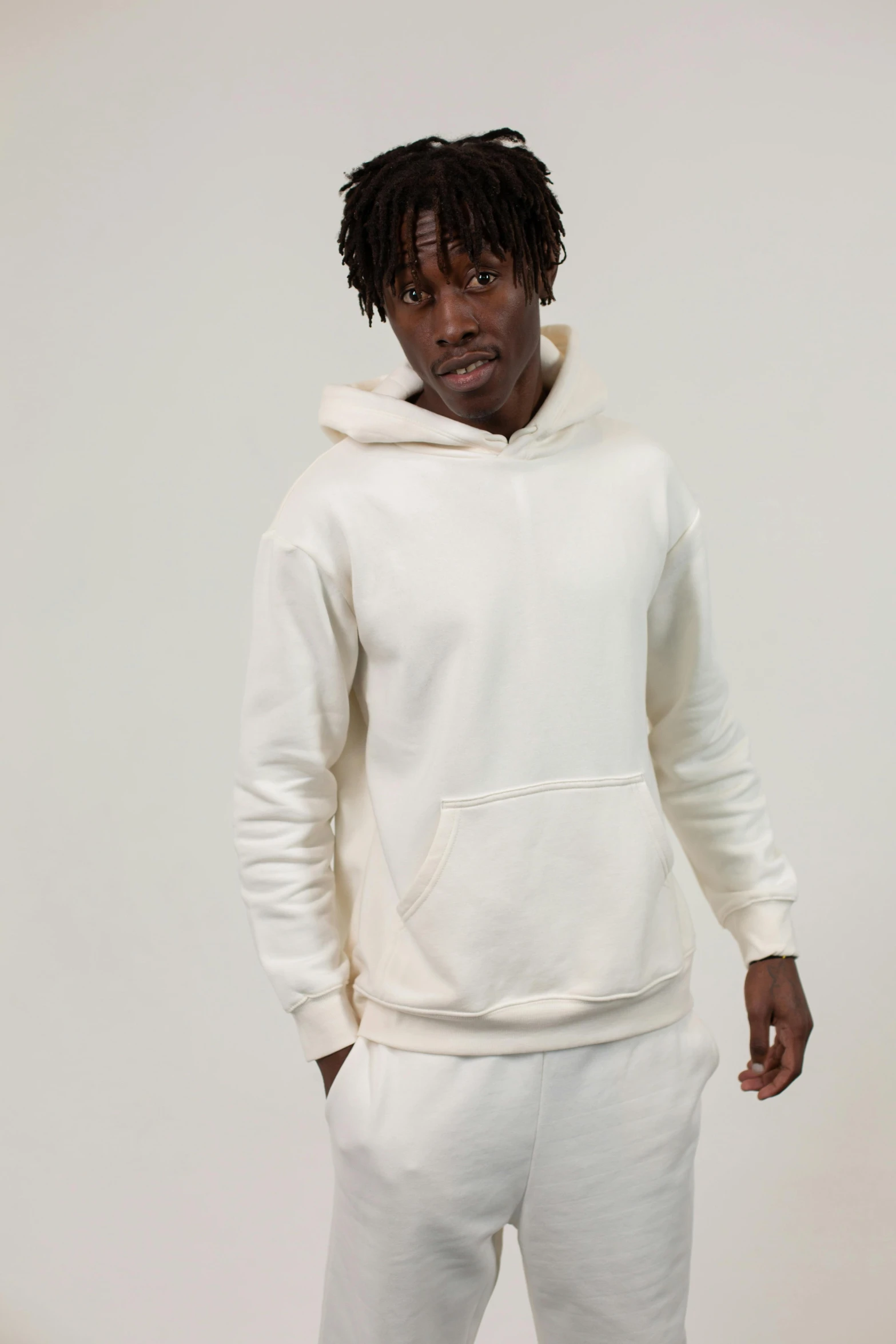 a man in a white hoodie standing in front of a white wall, yzy gap, ivory, thumbnail, hemp