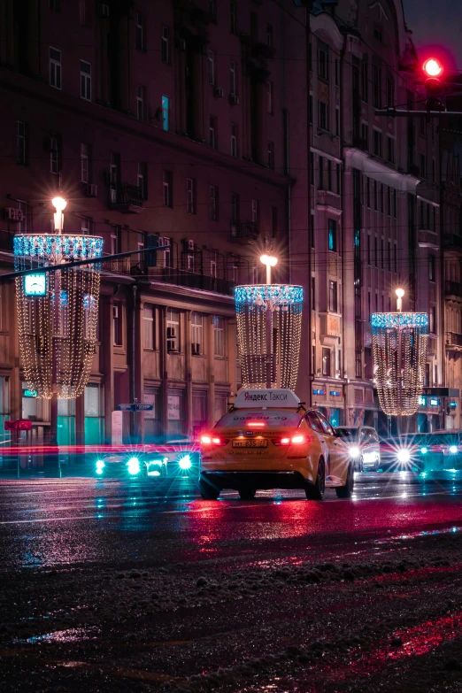 a city street filled with lots of traffic at night, a colorized photo, by Carlo Martini, unsplash contest winner, socialist realism, street signs, in moscow centre, wet street, high quality photo