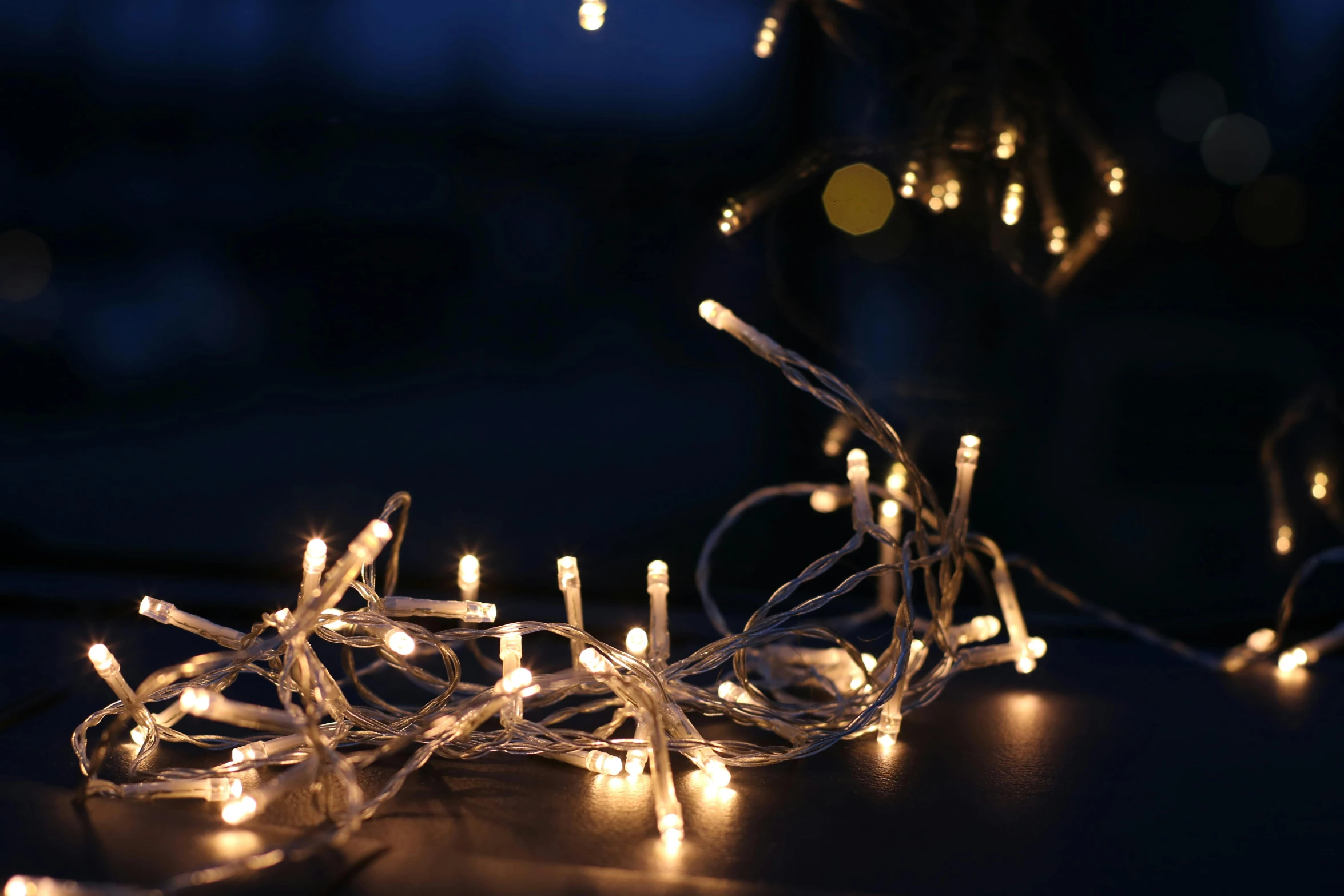 a close up of a string of lights on a table, inspired by Cerith Wyn Evans, pexels, hurufiyya, crackling lighting magic, winter sun, shot on sony a 7, festive