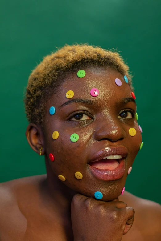 a woman with sprinkles on her face, african facial features, her face in discs, nonbinary model, 2019 trending photo