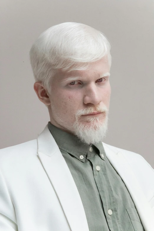 a man with white hair and a green shirt, inspired by Aleksander Gine, featured on reddit, renaissance, wearing futuristic white suit, bo burnham, shaved beard, non binary model