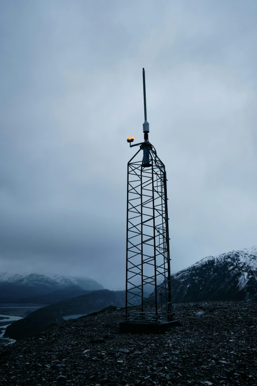 a tall tower sitting on top of a rocky hill, inspired by Simon Stålenhag, unsplash, kinetic art, alaska, radio equipment, cold, on display