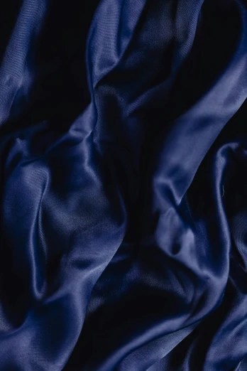 a close up of a blue silk fabric, inspired by Lorenzo Lotto, trending on pexels, wearing dark silk robe, midnight blue, asleep, blueberry